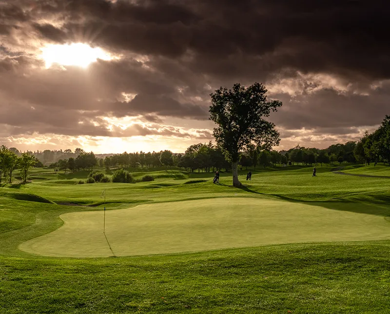 Dramatic clouds and sunlight over hole