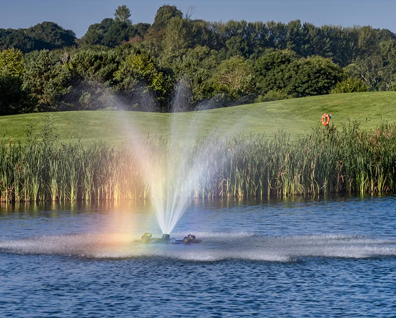 Rainbow being made by water feature